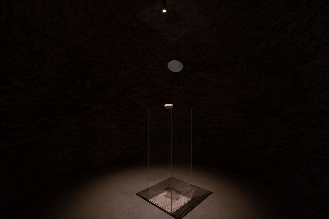 Stone in a lit vitrine within the brick dome
