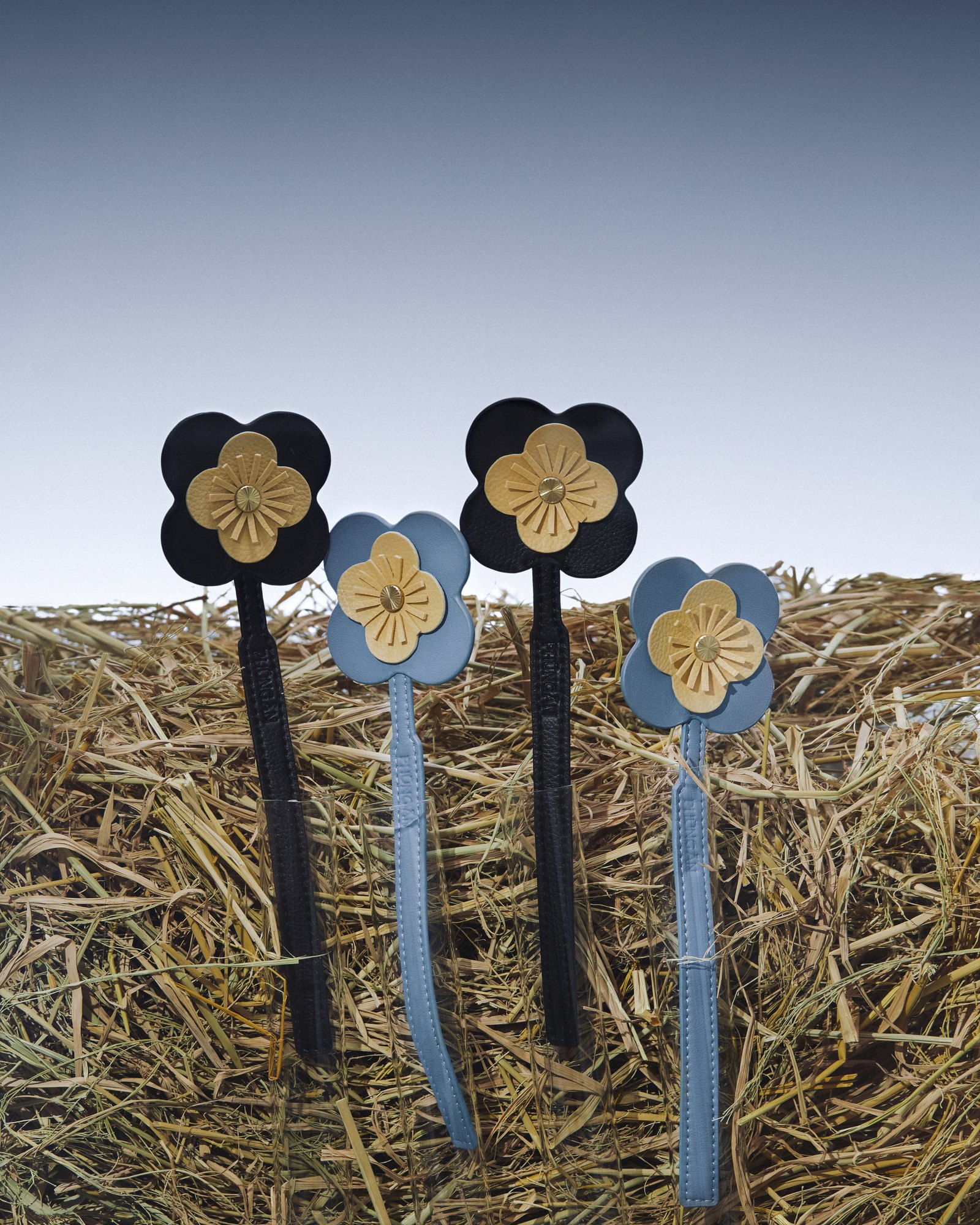 Flower charms standing in hay