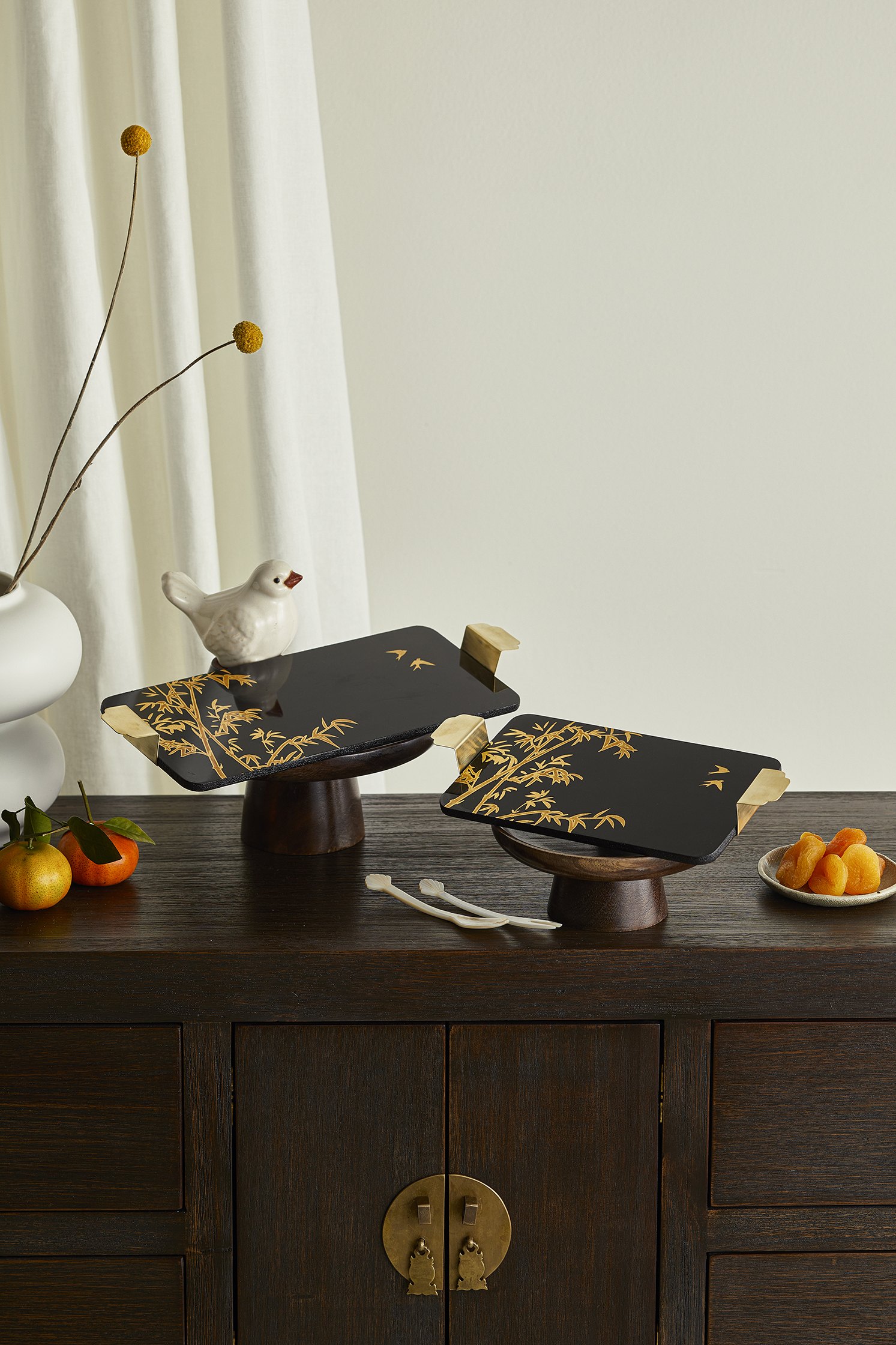Black lacquer trays on wooden stands